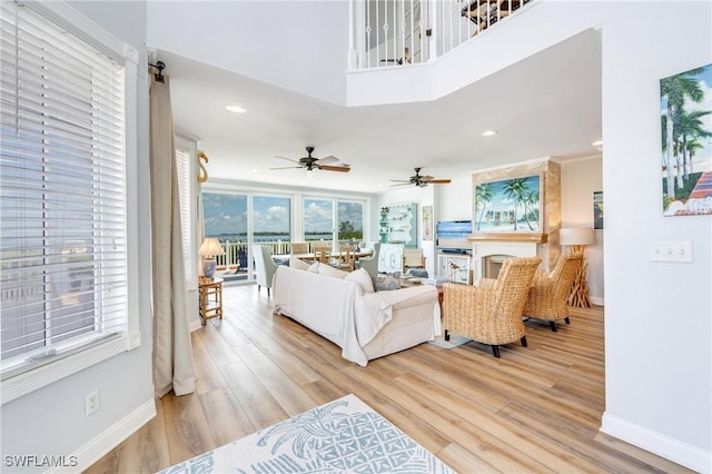living room featuring baseboards, wood finished floors, recessed lighting, and a ceiling fan