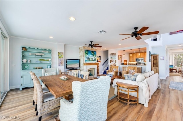 dining space featuring ceiling fan, light wood finished floors, recessed lighting, ornamental molding, and baseboards