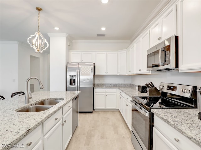 kitchen with stainless steel appliances, a sink, crown molding, white cabinetry, and recessed lighting