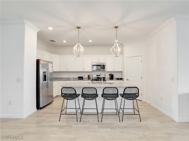 kitchen with appliances with stainless steel finishes, white cabinets, a chandelier, baseboards, and a kitchen breakfast bar