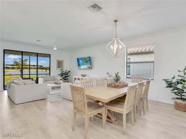 dining space featuring a chandelier, ornamental molding, ceiling fan, and baseboards