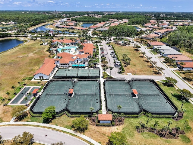 drone / aerial view of a large body of water and a pool area