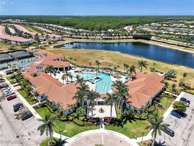 aerial perspective of suburban area featuring a nearby body of water and a pool area