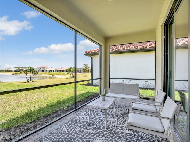 sunroom with a water view and healthy amount of natural light