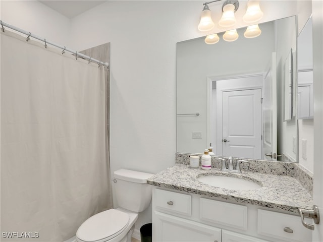 bathroom featuring vanity, toilet, and a shower with shower curtain