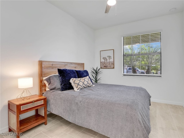 bedroom featuring ceiling fan and baseboards