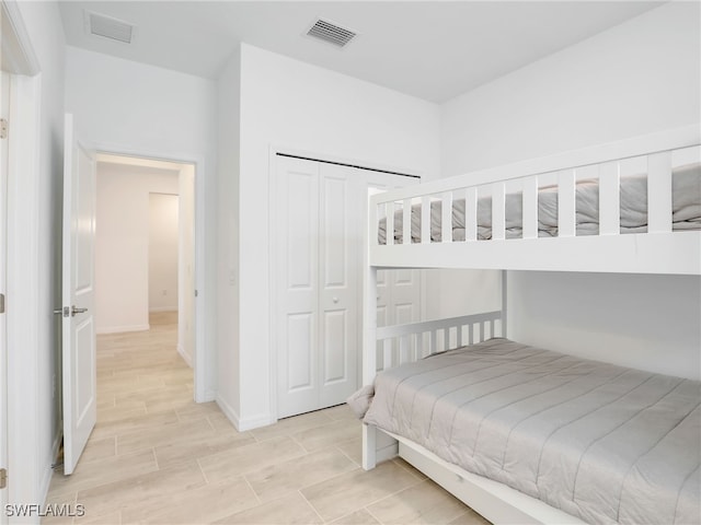 bedroom with baseboards and a closet