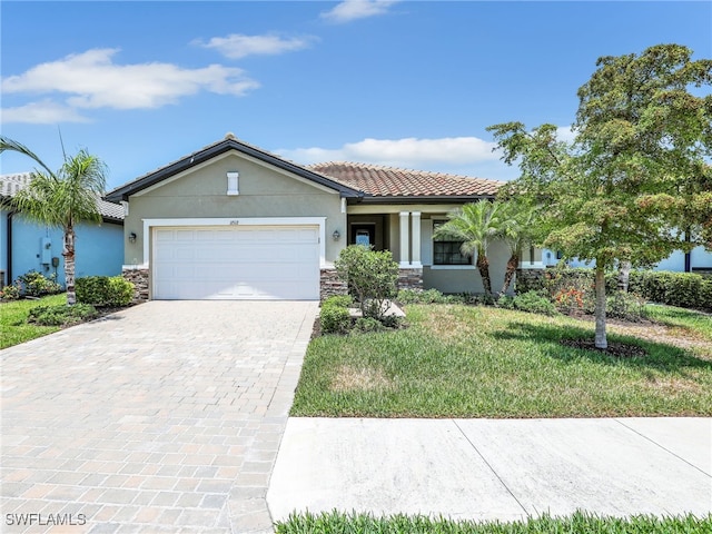 view of front of house with stone siding, stucco siding, decorative driveway, and a front yard