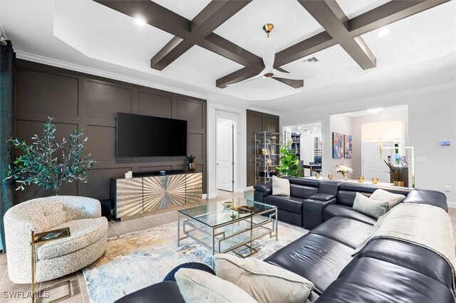 living area with coffered ceiling, ornamental molding, ceiling fan, beamed ceiling, and baseboards