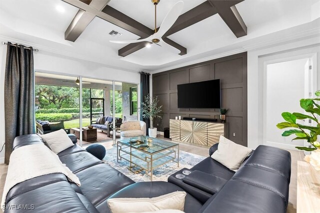 living area with coffered ceiling, a ceiling fan, baseboards, beamed ceiling, and light wood-type flooring