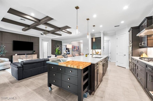 kitchen featuring open floor plan, coffered ceiling, a spacious island, recessed lighting, and a sink