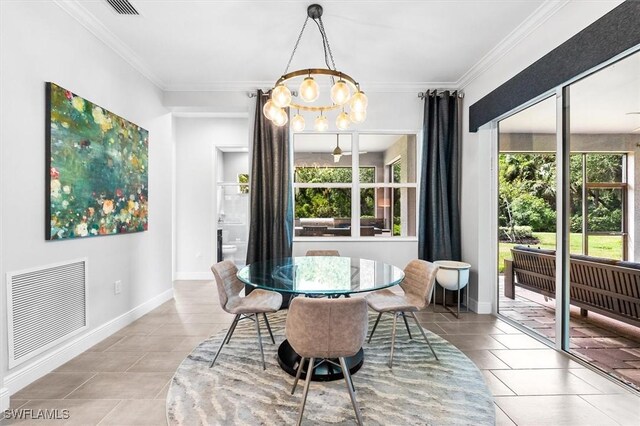 tiled dining area with a chandelier, crown molding, and baseboards