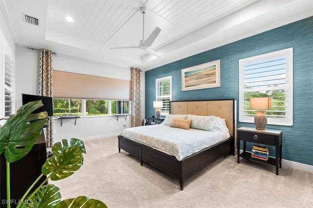 carpeted bedroom featuring baseboards, wallpapered walls, ceiling fan, and a raised ceiling