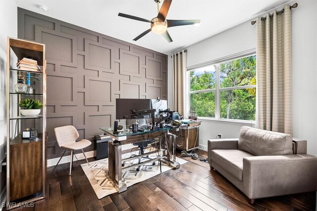 home office featuring a ceiling fan, baseboards, and dark wood finished floors