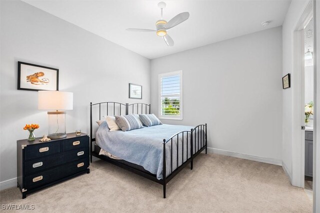 bedroom featuring light colored carpet, baseboards, and ceiling fan