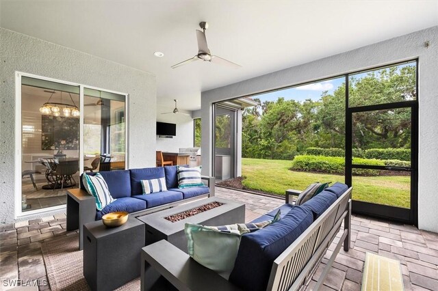 view of patio / terrace with an outdoor living space with a fire pit, a ceiling fan, and a grill
