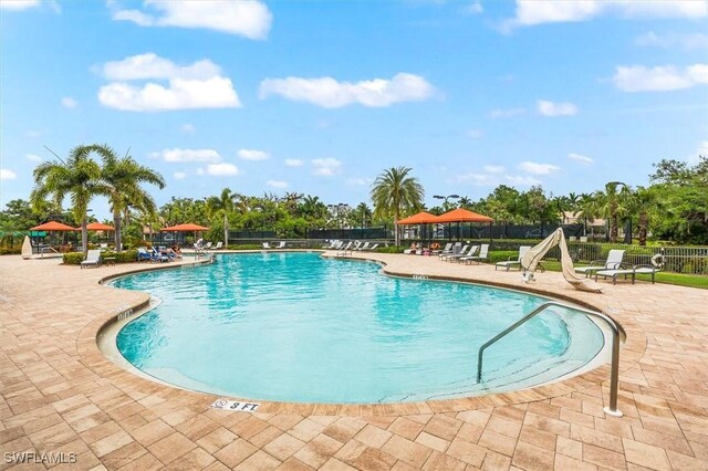 community pool featuring a patio and fence