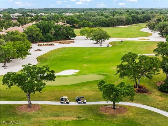 view of home's community with view of golf course and view of scattered trees
