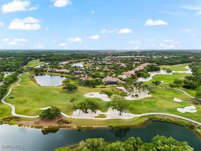 aerial view of property and surrounding area with nearby suburban area, a golf club, and a nearby body of water