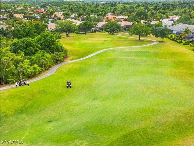 aerial view of residential area with a local golf course and a tree filled landscape