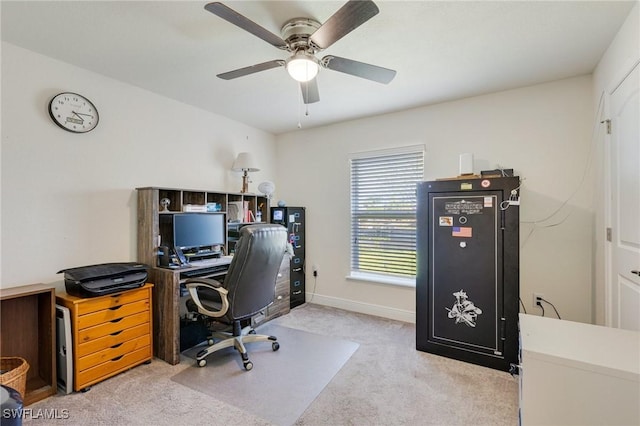 carpeted office featuring baseboards and ceiling fan