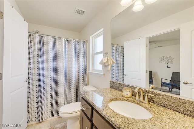 bathroom with toilet, visible vents, curtained shower, and vanity