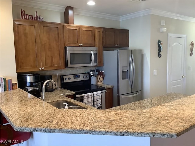 kitchen with a sink, brown cabinetry, stainless steel appliances, and light stone counters