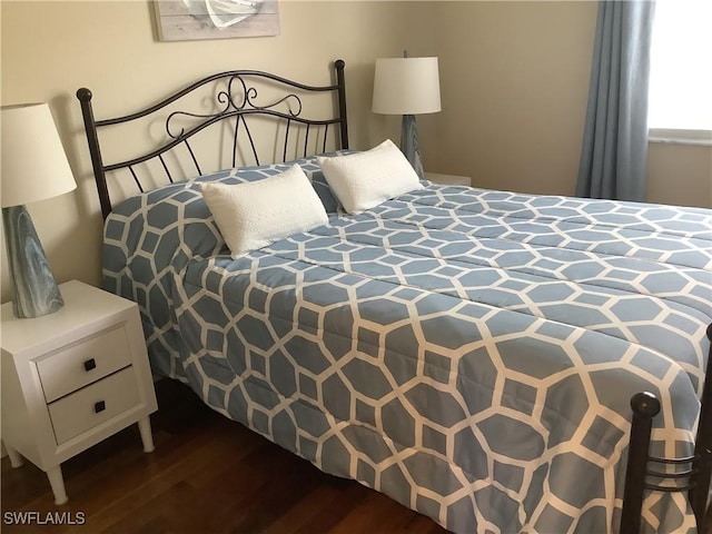 bedroom with dark wood-type flooring