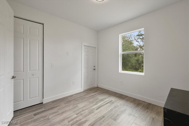 409 Columbus Blvd S, Lehigh Acres, FL 33974 - unfurnished bedroom featuring light wood-style flooring and baseboards
