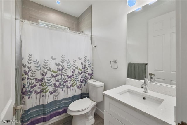 409 Columbus Blvd S, Lehigh Acres, FL 33974 - full bath featuring toilet, vanity, and a shower with shower curtain