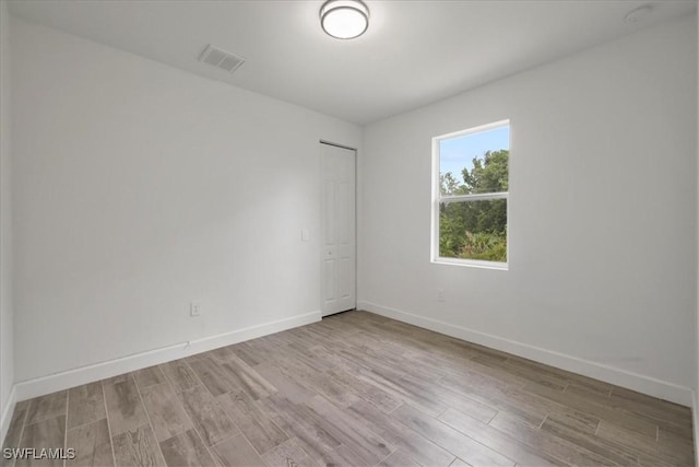 409 Columbus Blvd S, Lehigh Acres, FL 33974 - spare room with wood finished floors and baseboards