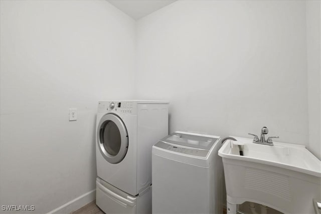 409 Columbus Blvd S, Lehigh Acres, FL 33974 - laundry room with washer and dryer and baseboards