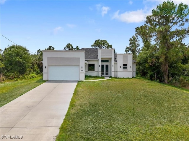 409 Columbus Blvd S, Lehigh Acres, FL 33974 - contemporary house featuring french doors, stucco siding, a garage, concrete driveway, and a front lawn