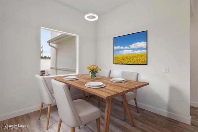 409 Columbus Blvd S, Lehigh Acres, FL 33974 - dining space featuring baseboards and wood finished floors