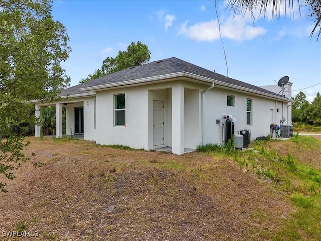 409 Columbus Blvd S, Lehigh Acres, FL 33974 - back of property with stucco siding and central AC unit