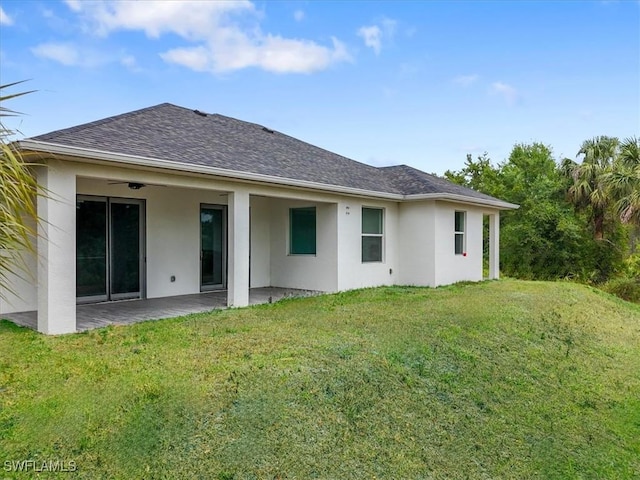 409 Columbus Blvd S, Lehigh Acres, FL 33974 - rear view of property featuring stucco siding, a patio area, and a yard