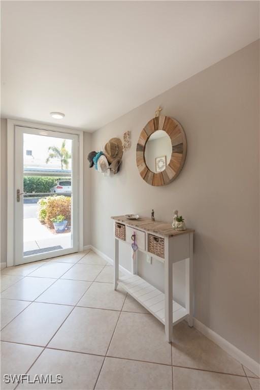 325 Charlemagne Blvd Unit A104, Naples, FL 34112 - entryway featuring light tile patterned floors and baseboards