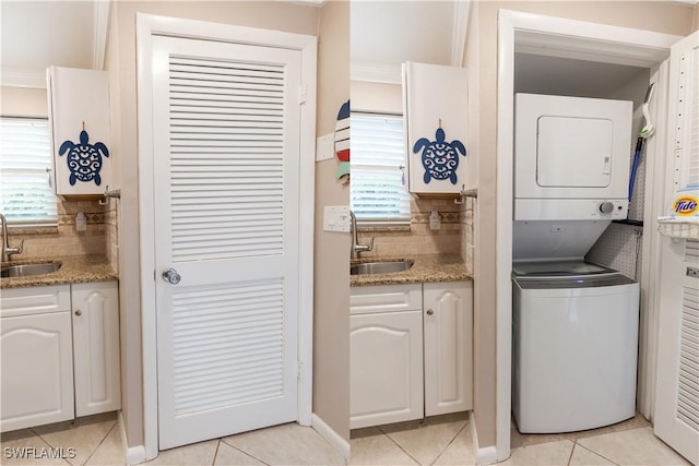 325 Charlemagne Blvd Unit A104, Naples, FL 34112 - laundry room with estacked washer and dryer, light tile patterned flooring, and bar with sink