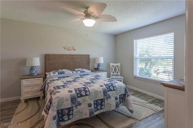325 Charlemagne Blvd Unit A104, Naples, FL 34112 - bedroom featuring wood finished floors, a textured ceiling, baseboards, and ceiling fan