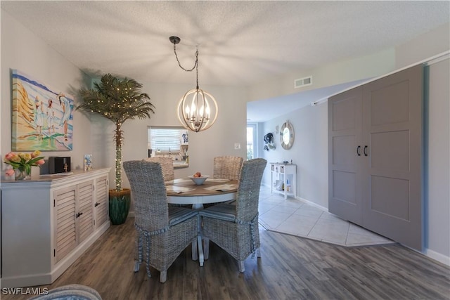 325 Charlemagne Blvd Unit A104, Naples, FL 34112 - dining room with a chandelier, wood finished floors, and baseboards
