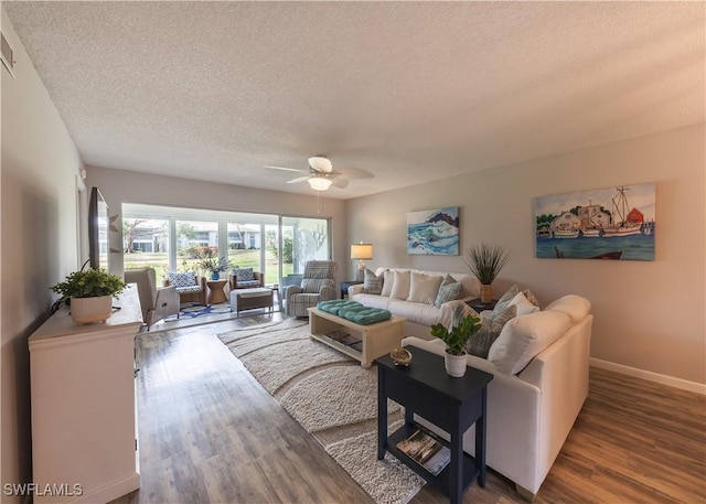 325 Charlemagne Blvd Unit A104, Naples, FL 34112 - living area featuring a textured ceiling, a ceiling fan, wood finished floors, and baseboards