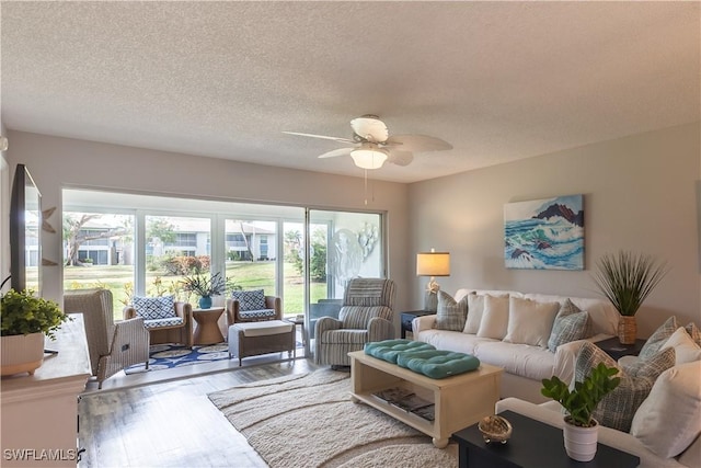 325 Charlemagne Blvd Unit A104, Naples, FL 34112 - living area with a ceiling fan, wood finished floors, and a textured ceiling