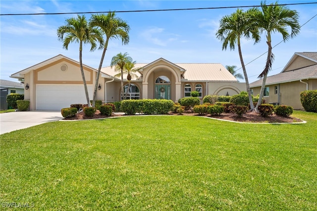 1222 SW 54th St, Cape Coral, FL 33914 - view of front of house featuring stucco siding, concrete driveway, an attached garage, and a front lawn