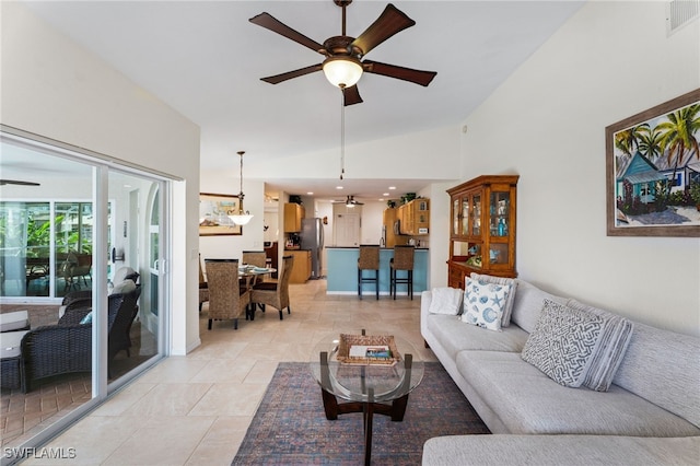 1222 SW 54th St, Cape Coral, FL 33914 - living room featuring ceiling fan, vaulted ceiling, baseboards, and light tile patterned floors