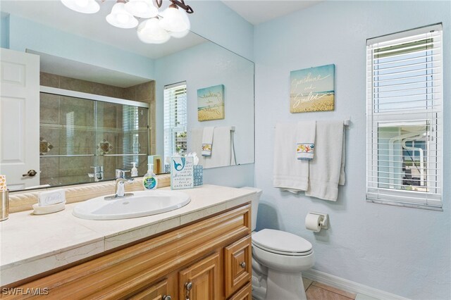 1222 SW 54th St, Cape Coral, FL 33914 - full bath with a stall shower, a chandelier, vanity, toilet, and tile patterned flooring