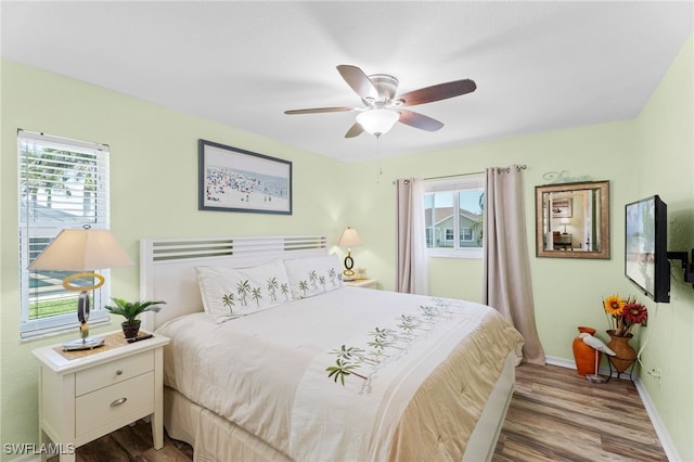 1222 SW 54th St, Cape Coral, FL 33914 - bedroom with wood finished floors, baseboards, and ceiling fan