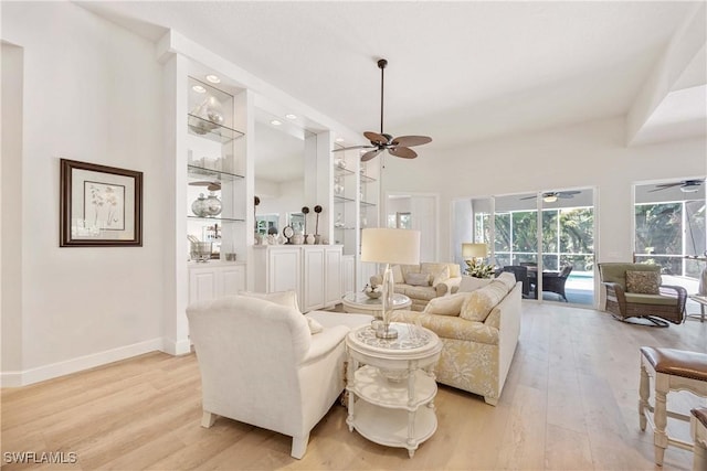 3803 Valentia Way, Naples, FL 34119 - living room with a ceiling fan, light wood-style floors, a sunroom, and built in features