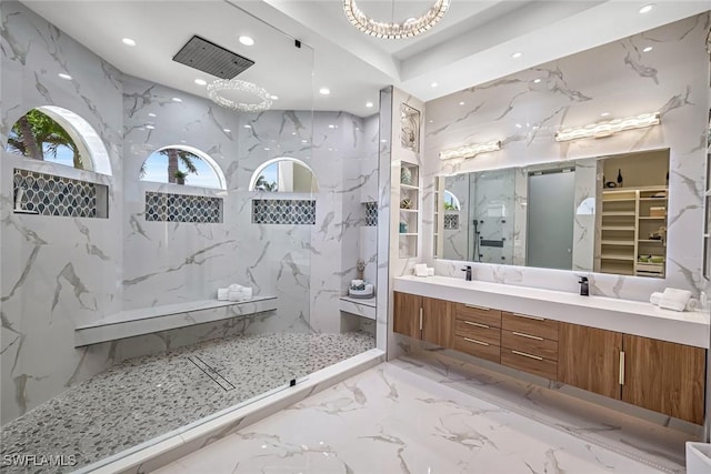 full bathroom featuring a marble finish shower, recessed lighting, marble tiled flooring, double vanity, and stone wall
