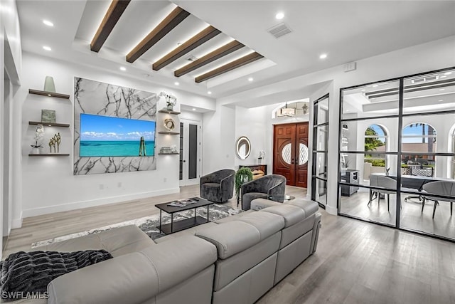 living area with wood finished floors and recessed lighting
