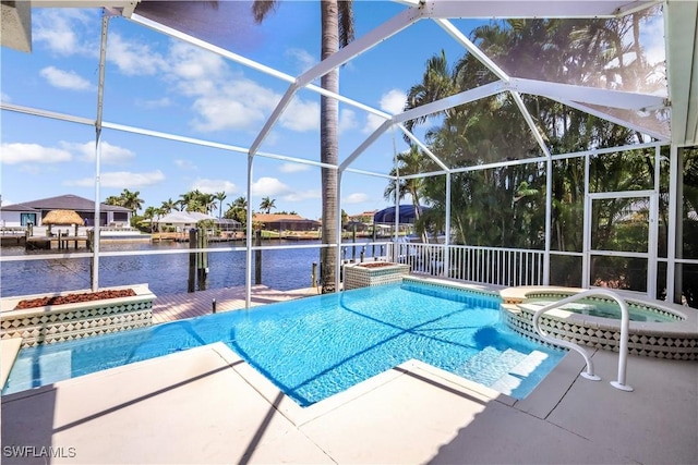view of pool with a water view, a pool with connected hot tub, a boat dock, and a patio